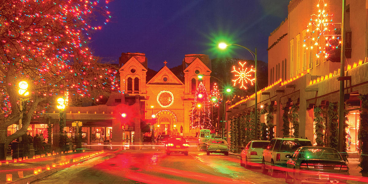 Santa Fe Plaza lit with Christmas lights and Farolitos at night